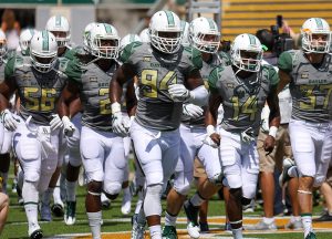 Baylor Bears defensive end Xavier Jones (94) leads his team onto the field to face the SMU Mustangs at McLane Stadium in Waco, Texas.