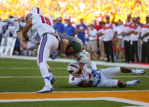 SMU Mustangs safety Mikial Onu (4) and defensive back Jordan Wyatt (15) upend Baylor Bears quarterback Seth Russell (17) near the goal line during the fourth quarter at McLane Stadium in Waco, Texas.