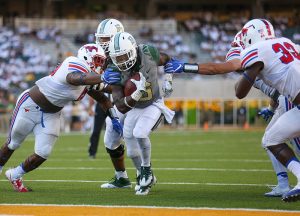 Baylor Bears running back JaMycal Hasty (6) breaks through attempted arm tackles by SMU Mustangs defenders for a touchdown at McLane Stadium in Waco, Texas.