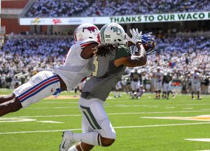 SMU Mustangs wide receiver James Proche (3) leaps to make a catch near the sideline against a Baylor Bears defender in the first quarter at McLane Stadium in Waco, Texas.