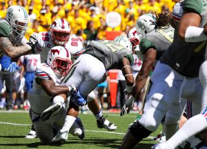 SMU Mustangs linebacker Kyran Mitchell (11) wraps up Baylor Bears running back Shock Linwood (32) behind the line of scrimmage during the second quarter at McLane Stadium in Waco, Texas. Mitchell, a true freshman, recorded 8 solo tackles in the game.